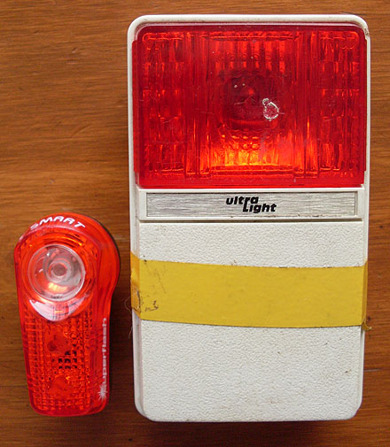 Current day Super Flash tail light beside a old Ultra Light tail light