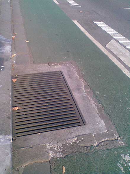Photo showing a drain cover that has been modified to make it less of a crash hazard for cyclists.